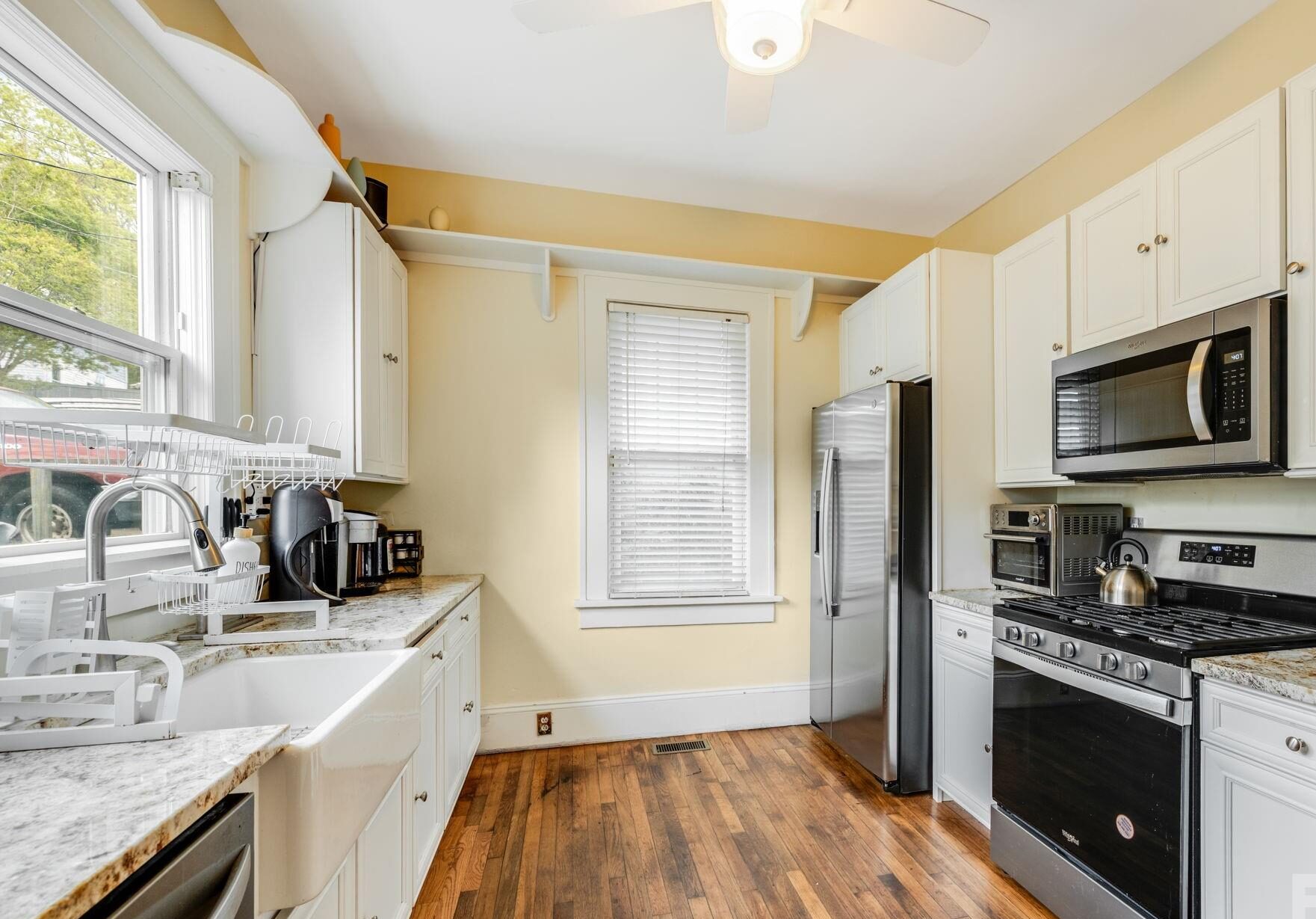Refinished kitchen cabinets and trim by Kola Kind Painting